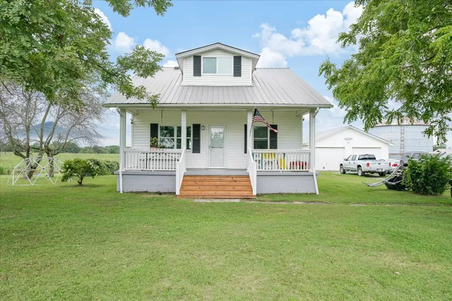 a front view of house with yard and green space