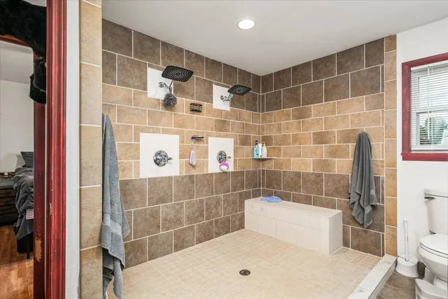 a bedroom with furniture and a wooden floor