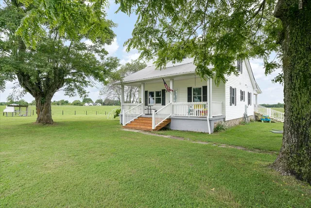 a view of a house with a backyard porch and sitting area