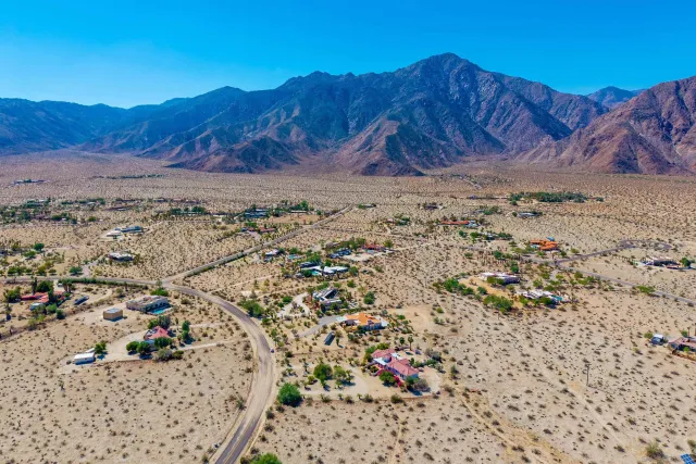 a view of a dry yard with a mountain