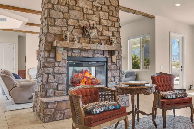 a living room with furniture a fireplace and a table