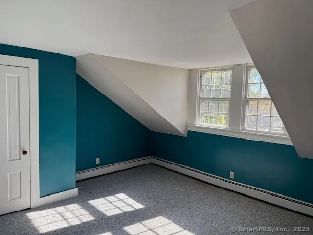 a view of an empty room with a window and stairs
