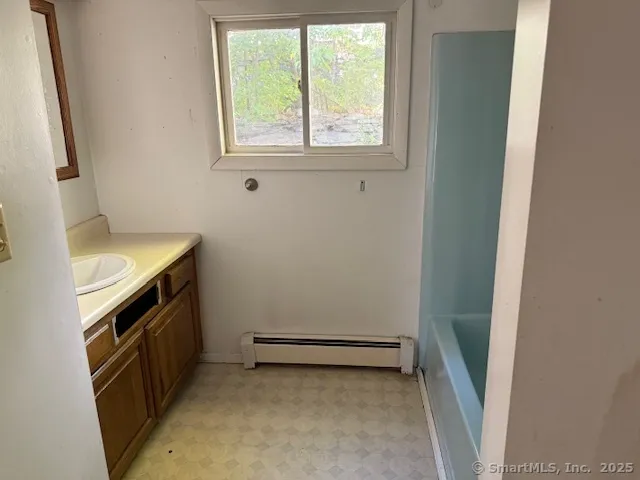 a view of a storage and utility room with a washer dryer