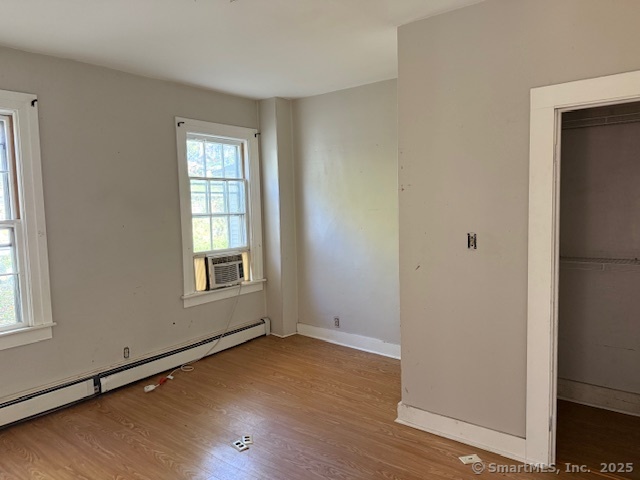 41 Spring Street Windham, CT 06226 - Photo 5 of 15 a view of an empty room with wooden floor and a window