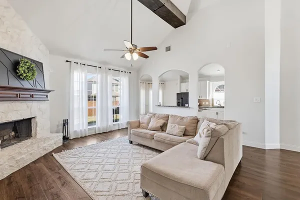 a living room with furniture and a fireplace