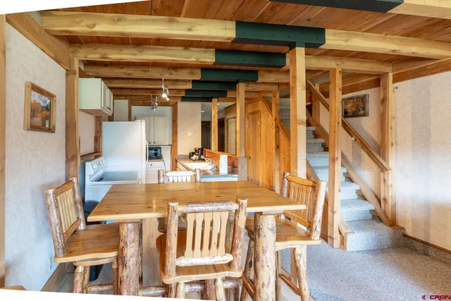 a view of a dining room with furniture wooden floor and a chandelier