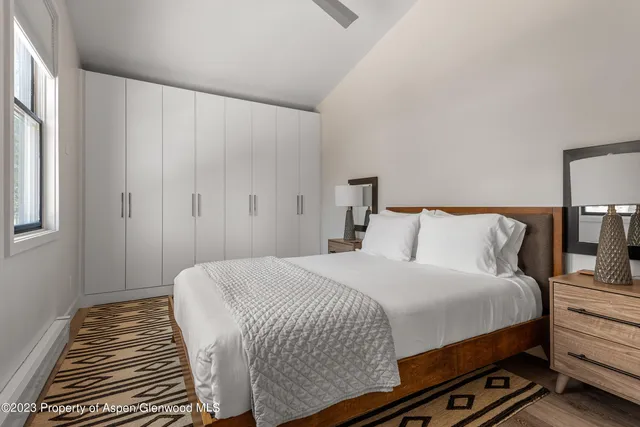 a bedroom with a bed and a night stand