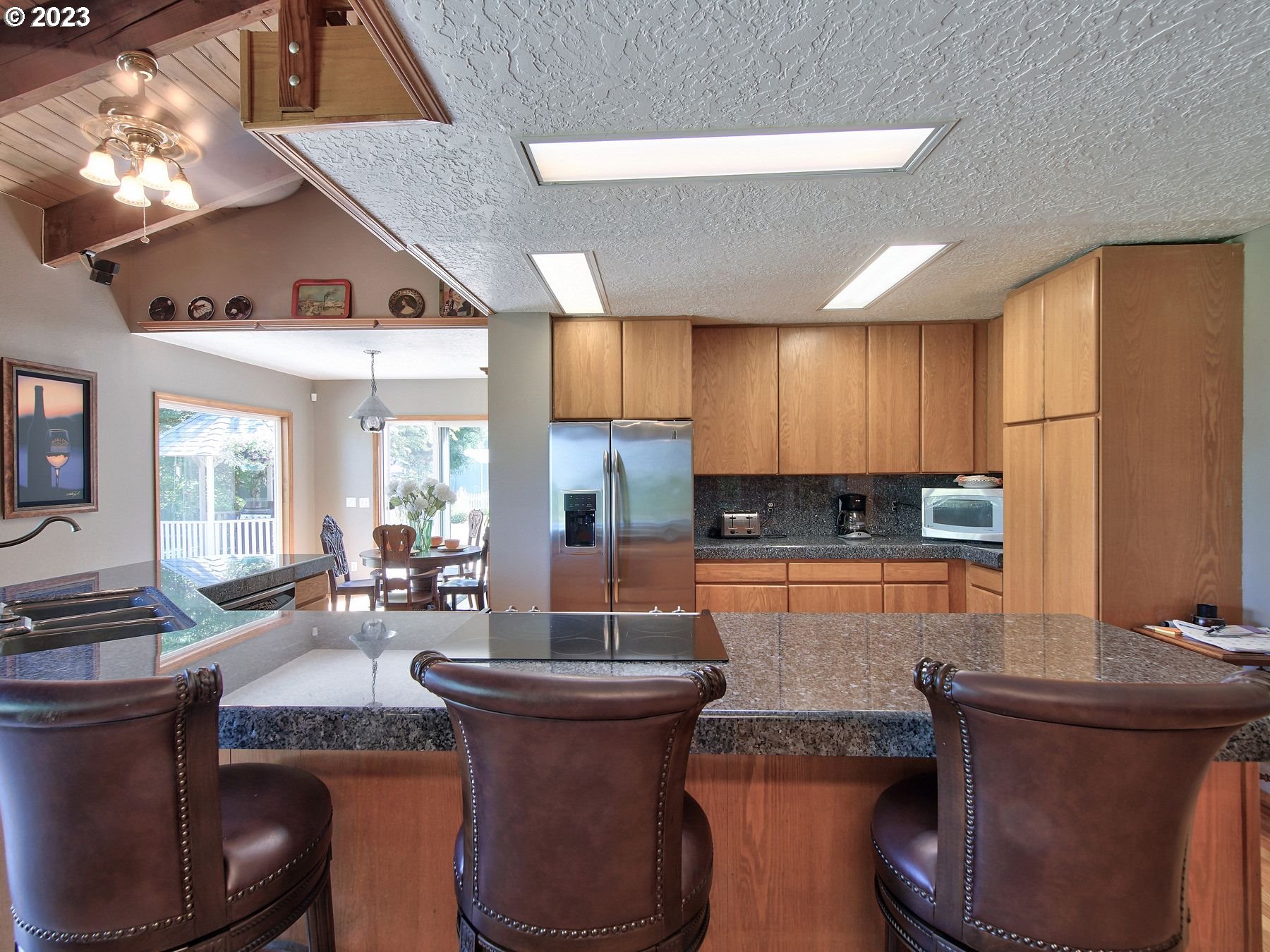 12773 South Union Hall Road Canby, OR 97013 - Photo 12 of 47 a kitchen with sink a stove and chairs