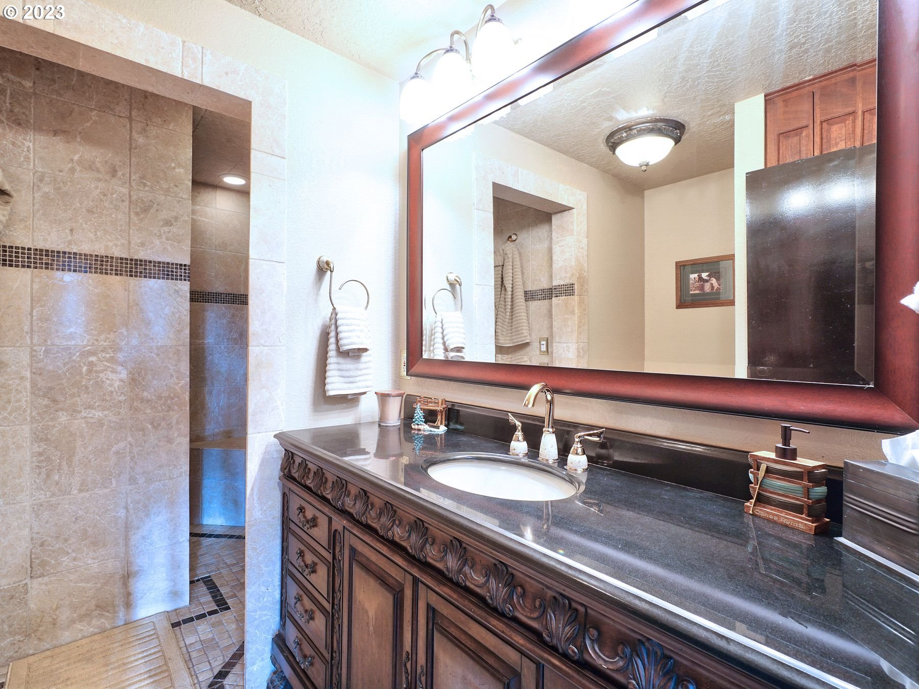 12773 South Union Hall Road Canby, OR 97013 - Photo 31 of 47 a bathroom with a granite countertop sink a mirror and shower