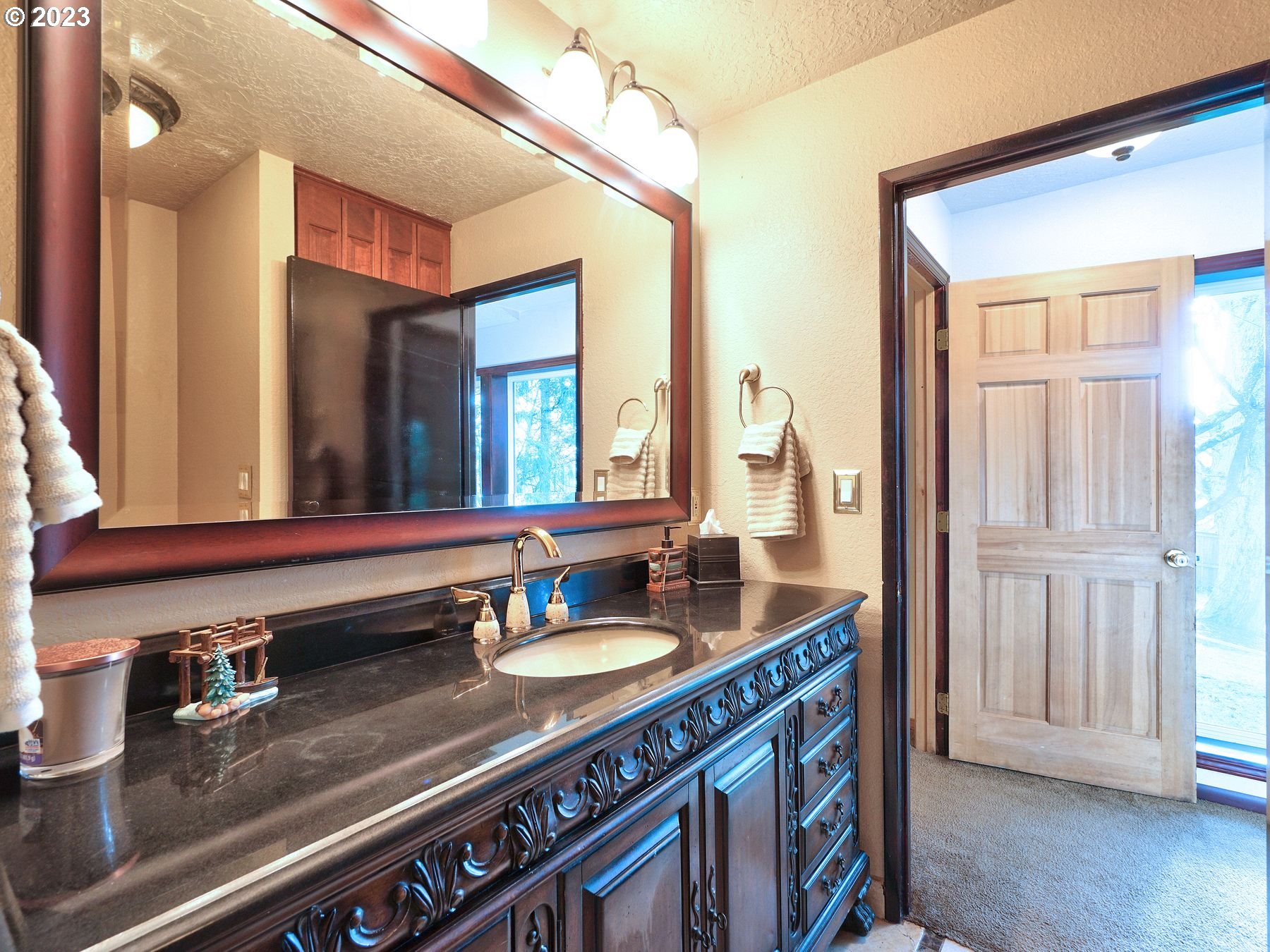 12773 South Union Hall Road Canby, OR 97013 - Photo 32 of 47 a bathroom with a granite countertop sink and a mirror