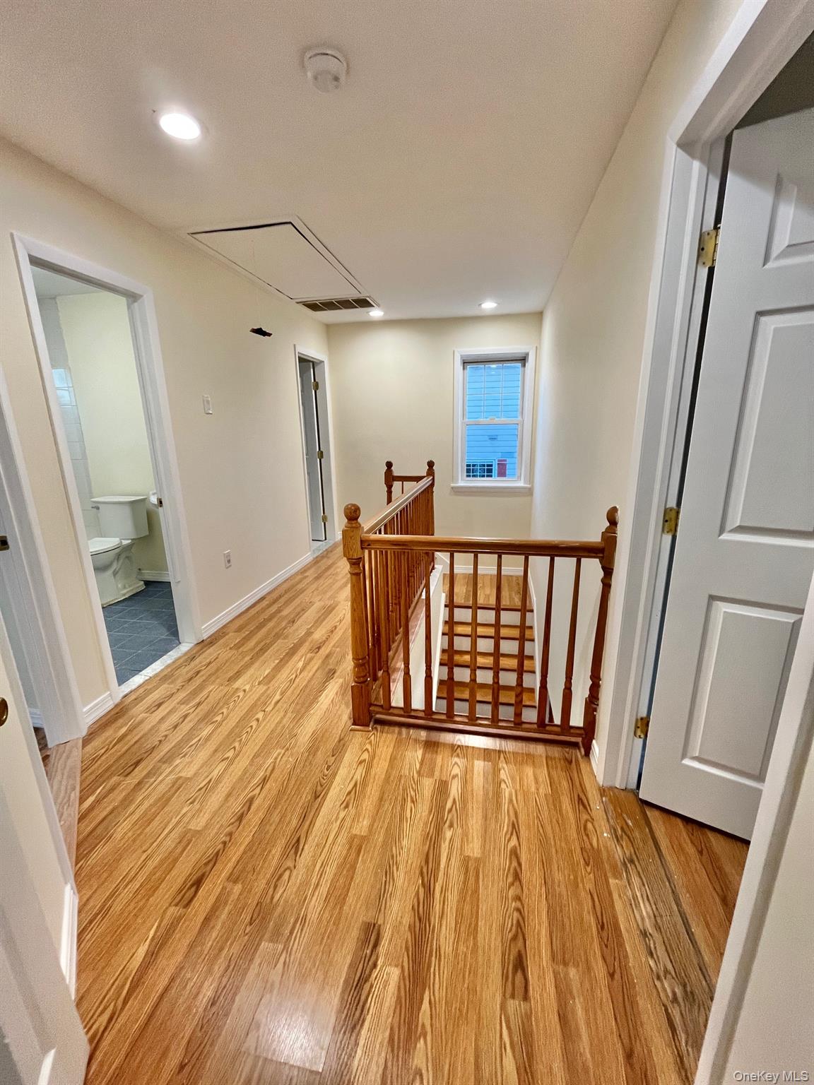 51 Emmett Terrace, Unit 1 New Rochelle, NY 10805 - Photo 12 of 23 a view of hallway with wooden floor and staircase