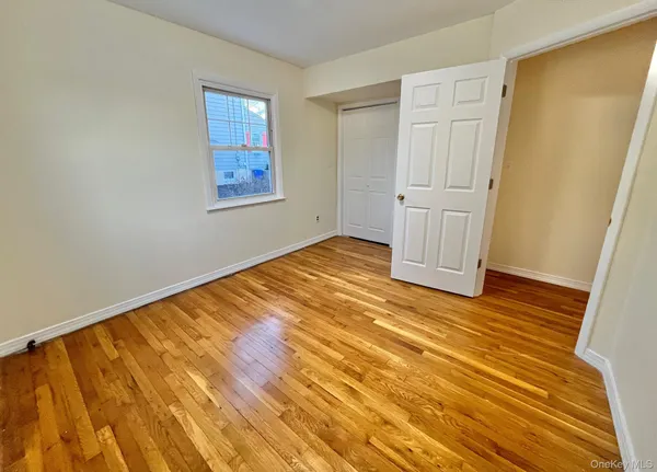 a view of a room with wooden floor and cabinet