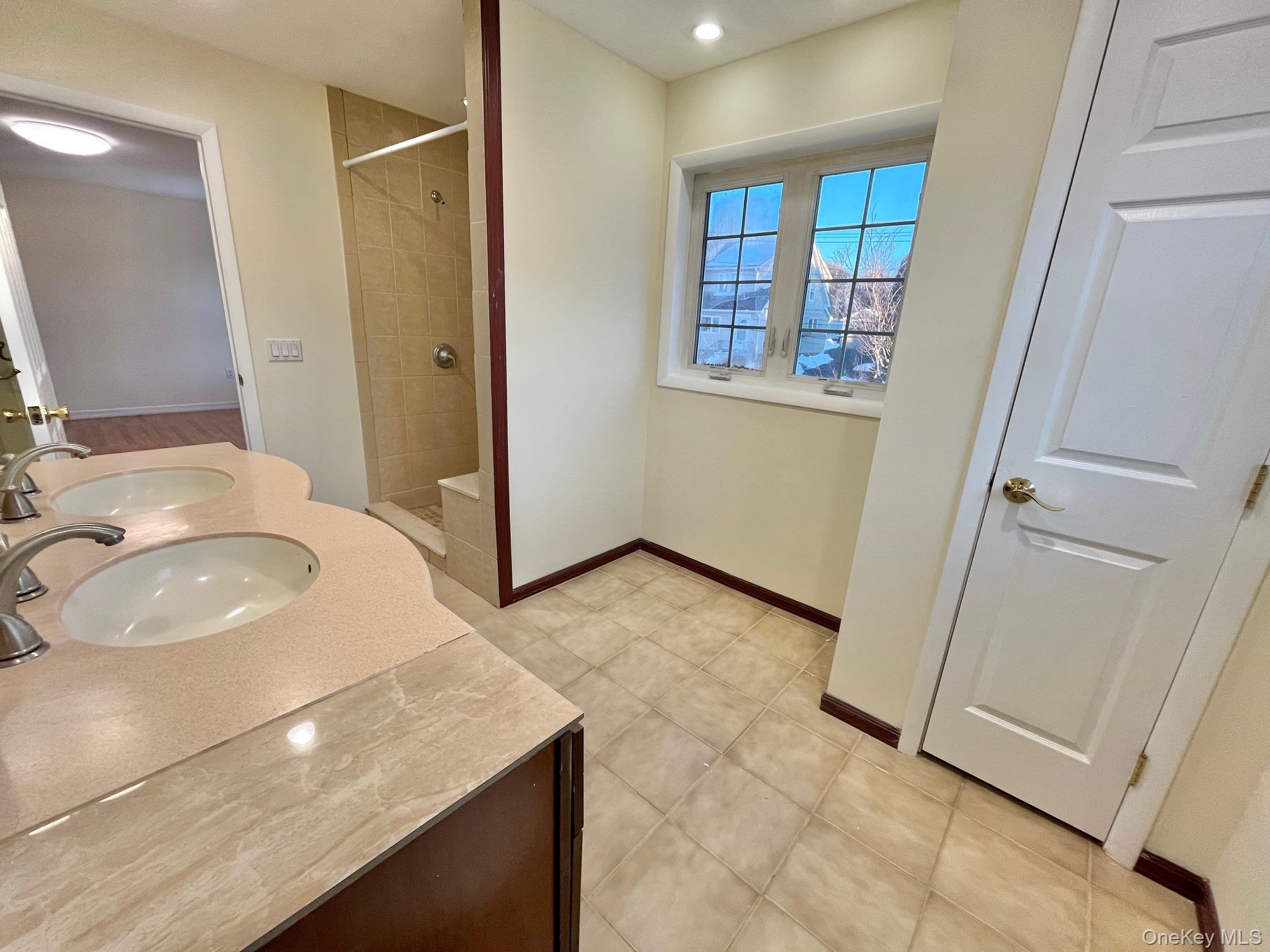 51 Emmett Terrace, Unit 1 New Rochelle, NY 10805 - Photo 22 of 23 a bathroom with a sink a toilet and a shower