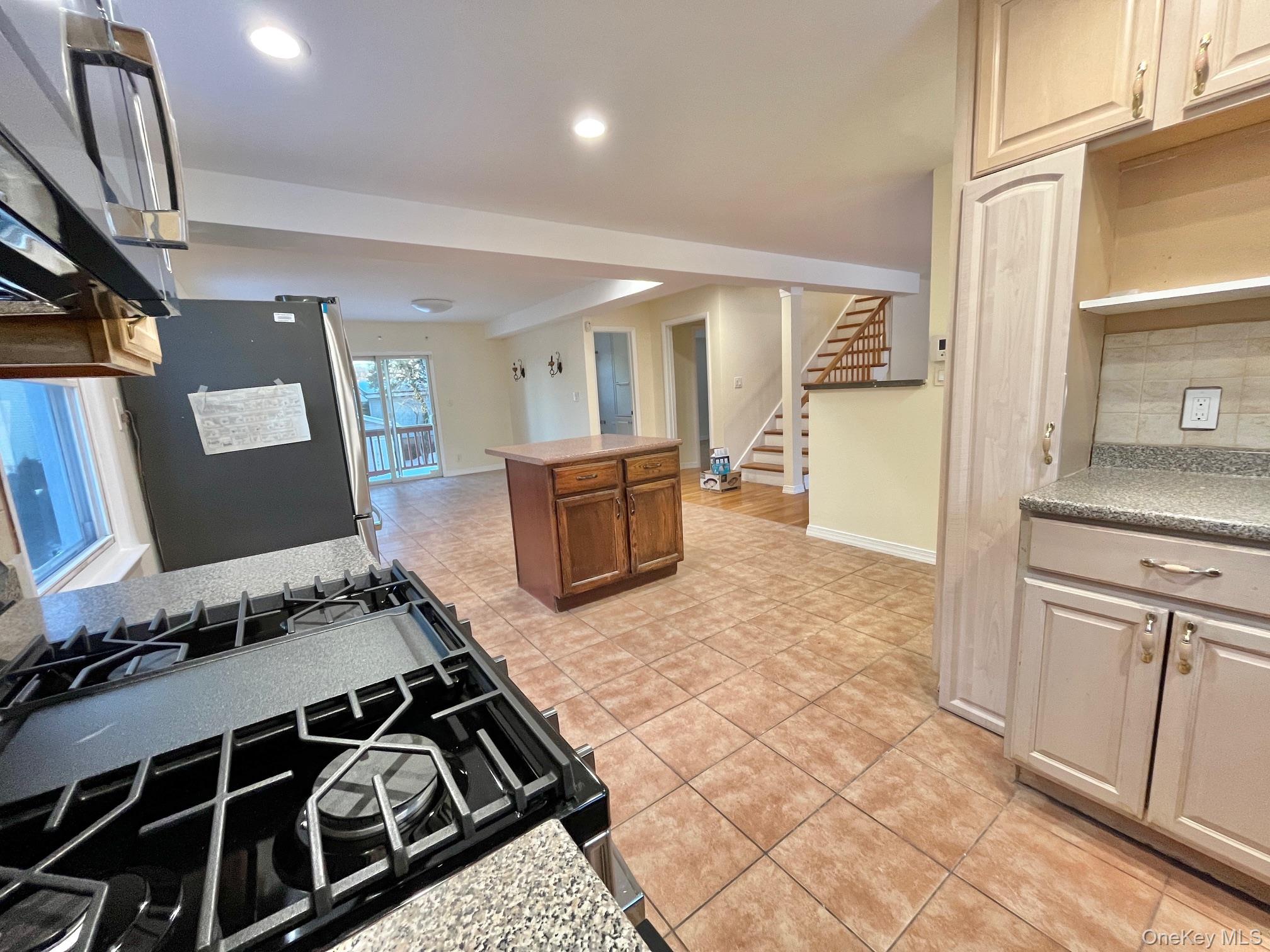 51 Emmett Terrace, Unit 1 New Rochelle, NY 10805 - Photo 4 of 23 a kitchen with granite countertop a stove and a sink
