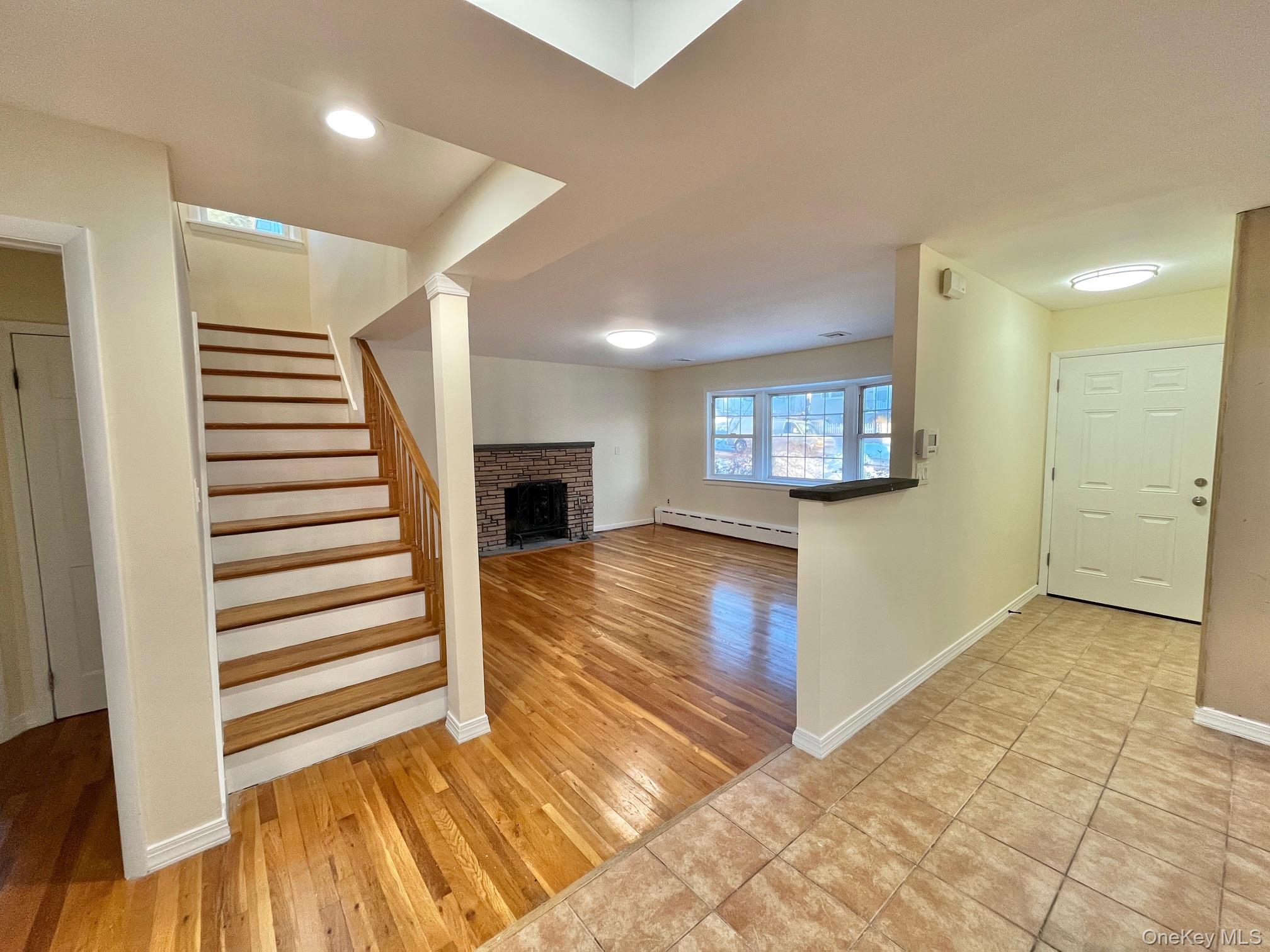 51 Emmett Terrace, Unit 1 New Rochelle, NY 10805 - Photo 8 of 23 a view of a living room with a fireplace and wooden floor