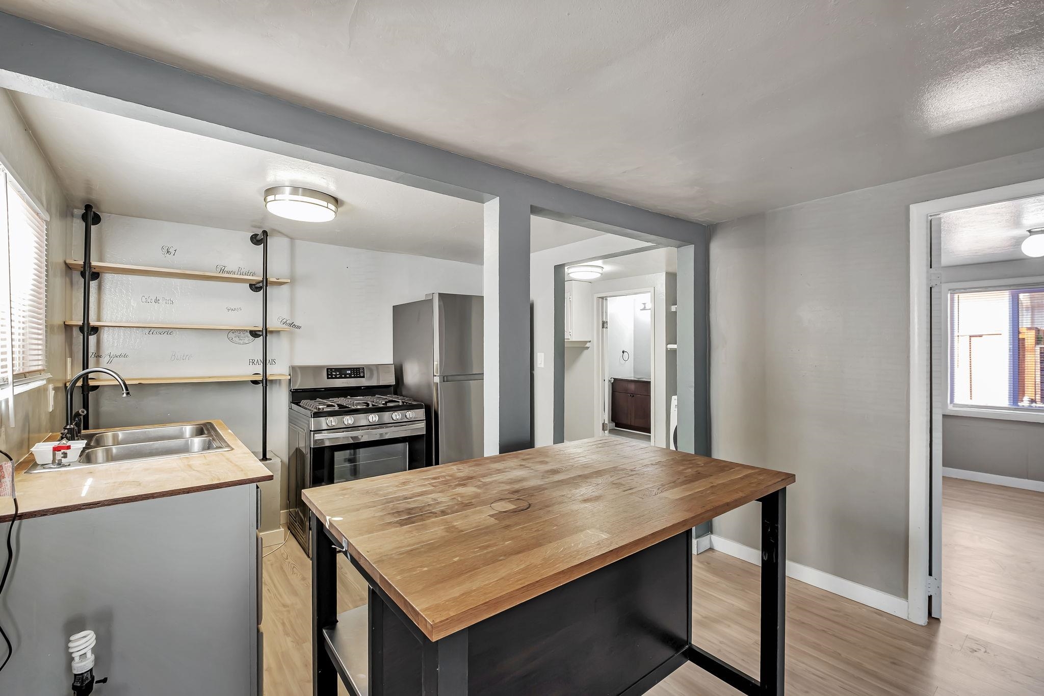 118 Sycamore Street Fremont, CA 94536 - Photo 11 of 30 a kitchen with a wooden floor and cabinets