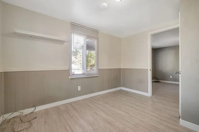 an empty room with windows and closet