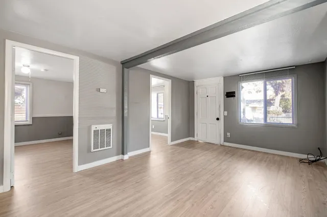 wooden floor in an empty room with a window