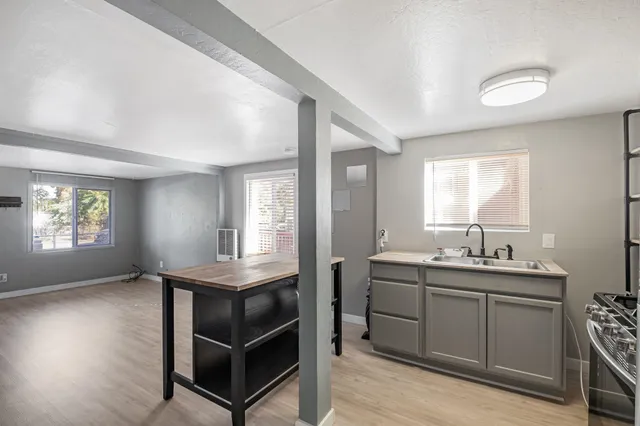 a kitchen with kitchen island a refrigerator stove microwave and sink