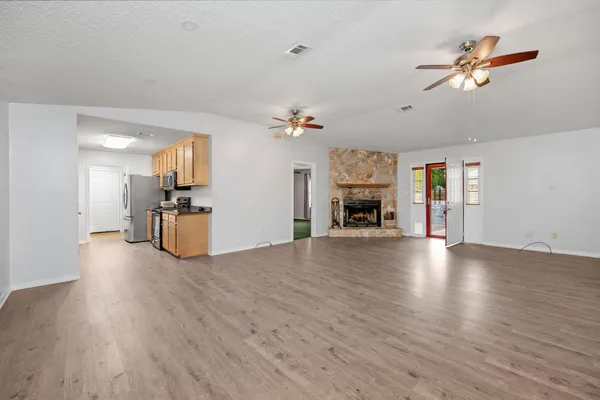 a large living room with furniture and a fireplace