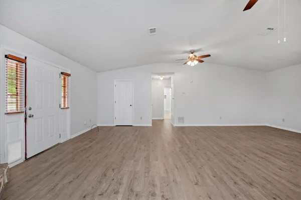 a view of empty room with ceiling fan