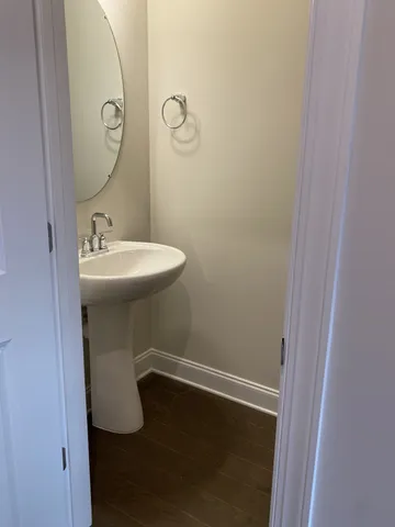 a kitchen with stainless steel appliances granite countertop a refrigerator a sink a stove and white cabinets