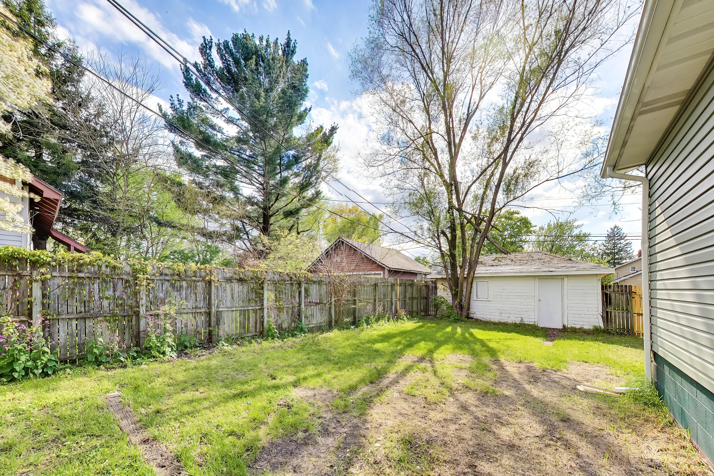 121 Faulkner Street Michigan City, IN 46360 - Photo 15 of 15 a view of backyard with a garden and tree