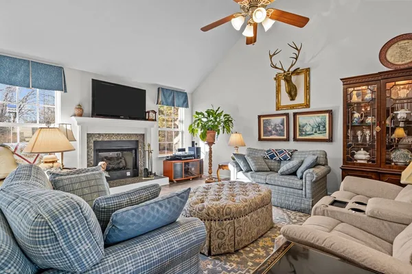 a living room with furniture a flat screen tv and a fireplace