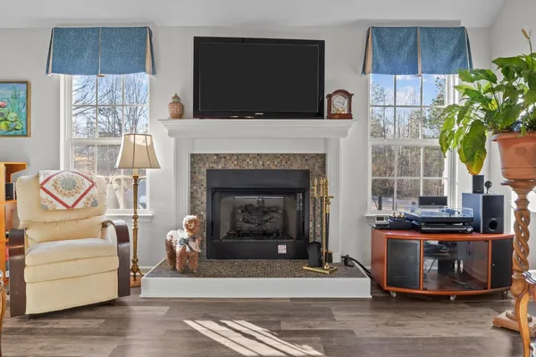a living room with furniture a dining table and a chandelier
