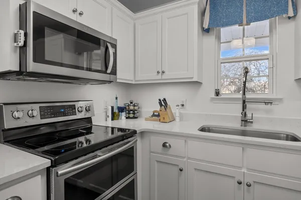a kitchen with stainless steel appliances a refrigerator and a wooden cabinets