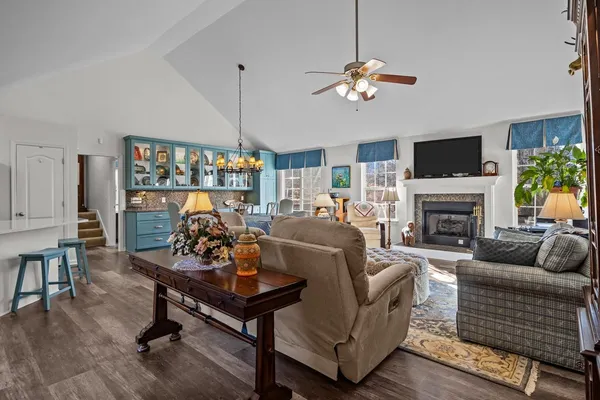 a living room with furniture a fireplace and a flat screen tv