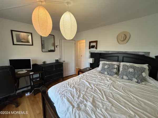 a bedroom with bed and a chandelier