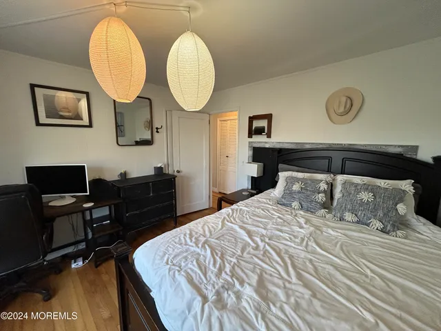 a bedroom with bed and a chandelier