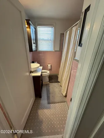 a bathroom with a sink a toilet and a mirror