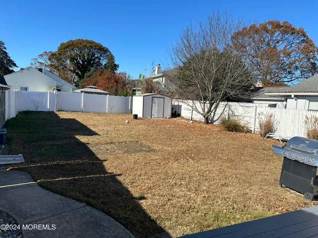 a view of a backyard of the house