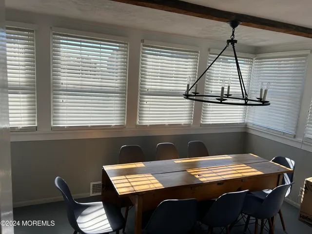 a view of a dining room with furniture and window
