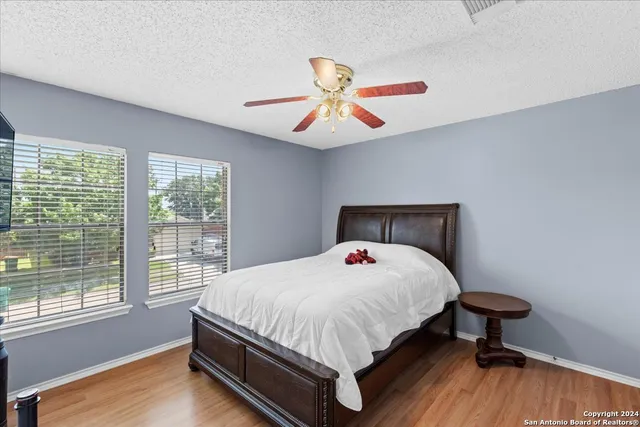 a bedroom with a bed and wooden floor