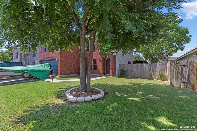 a view of a backyard with table and chairs