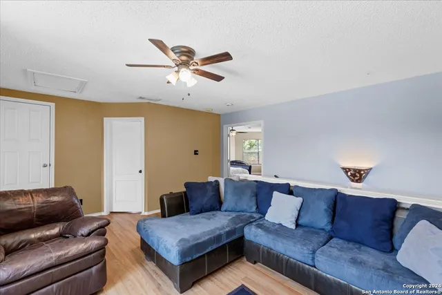 a living room with furniture and a wooden floor