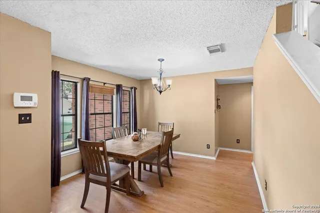 a view of a dining room with furniture and window