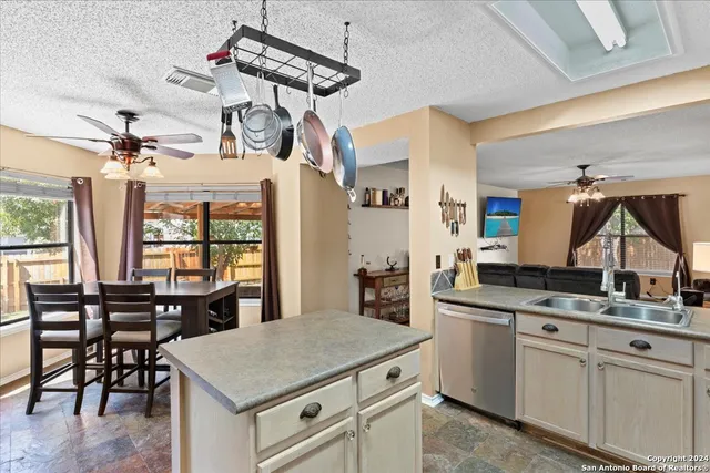 a kitchen with a table chairs cabinets and wooden floor