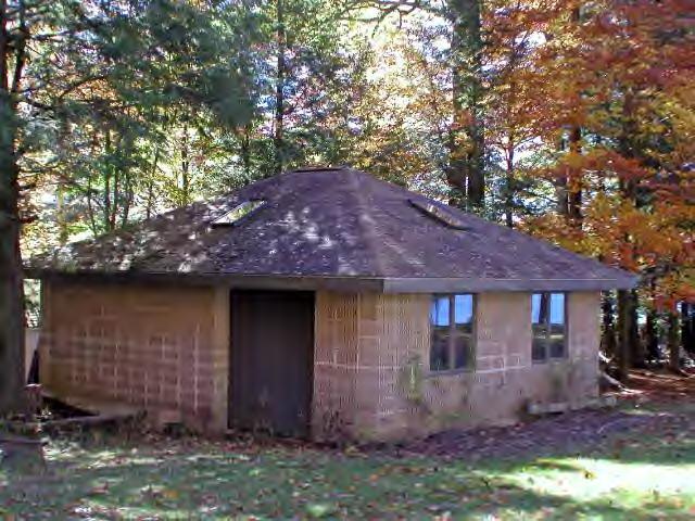 262-264 Kibbe Road Otis, MA 01029 - Photo 9 of 16 a front view of a house with a garden