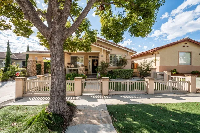 a front view of a house with a yard table and chairs