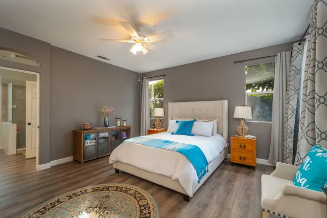 a bedroom with a bed and wooden floor