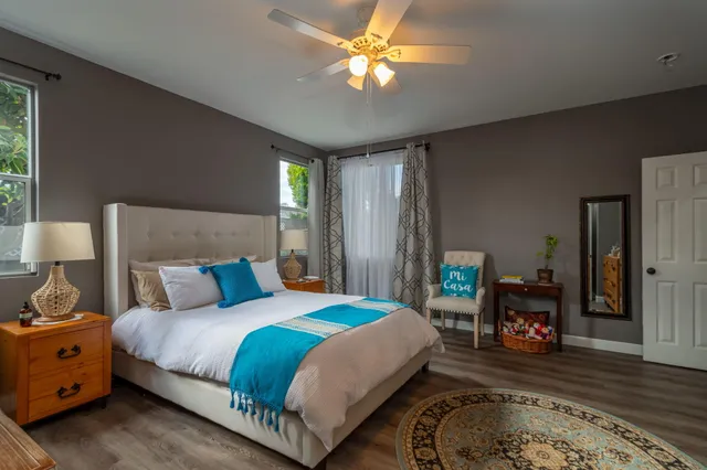 a bedroom with a bed and a chandelier