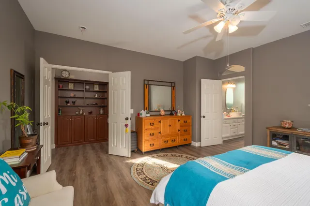 a bedroom with a bed and a dresser in it