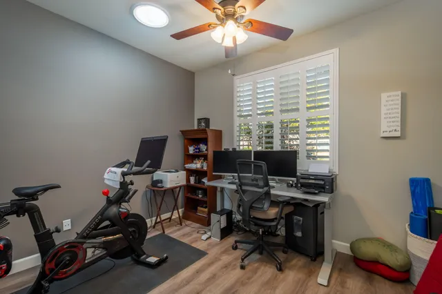 a view of a workspace with furniture and a window
