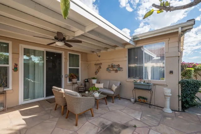 a view of a patio with table and chairs and potted plants