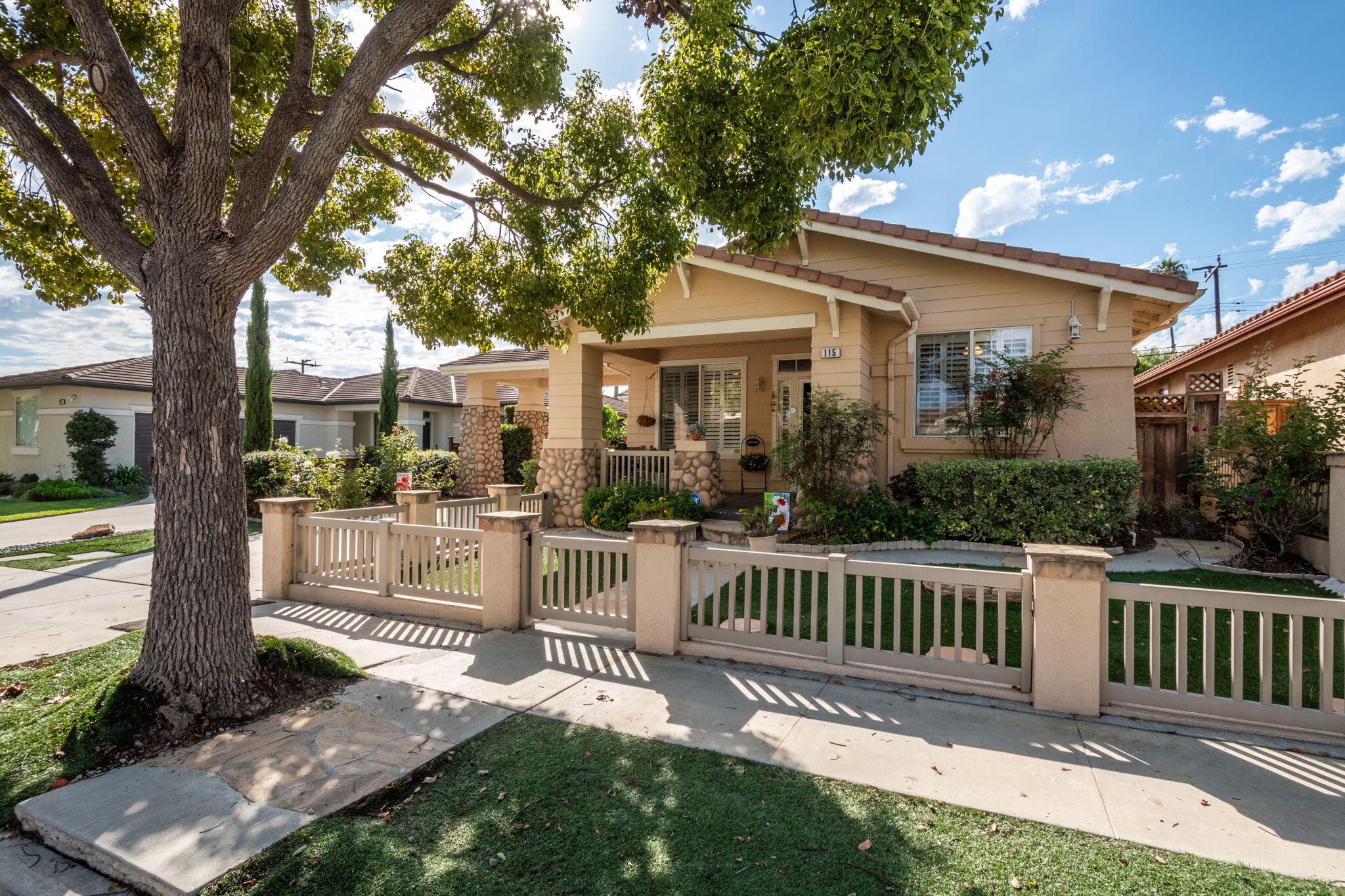 115 Ford Avenue Ventura, CA 93003 - Photo 30 of 33 a view of a house with a yard and potted plants and a large tree