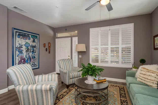 a living room with furniture and a potted plant